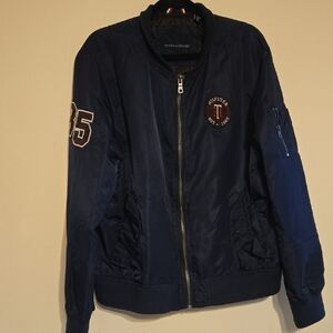 Tommy Hilfiger Blue Bomber Jacket with Rib and Patch accents.For Men And Women.